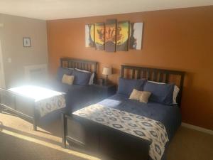 a bedroom with two beds with blue pillows at 2 Bedroom Cozy Shanty Creek Condo in Bellaire