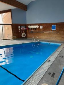 a large swimming pool with blue water at 2 Bedroom Cozy Shanty Creek Condo in Bellaire
