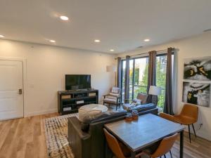 a living room with a couch and a table at Capri Condo in Downtown Traverse City in Traverse City