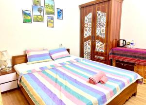 a bedroom with a bed with two slippers on it at Huong Thao Hostel & Tours in Dien Bien Phu