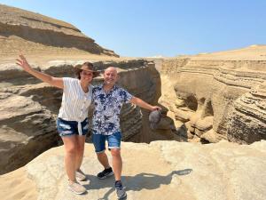 a man and a woman standing on some rocks at Harmony Inn Miraflores in Lima