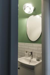 a bathroom with a sink and a mirror at VILLA TOURI - Touri Alpesi Birtok in Bozsok