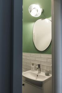 a bathroom with a sink and a mirror at VILLA TOURI - Touri Alpesi Birtok in Bozsok +26 photos