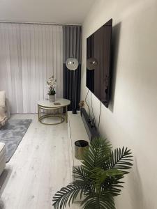 a living room with a table and a tv on a wall at Inviting 1-Bed Apartment in London in London