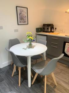 a kitchen with a table and chairs in a room at Ouse House in Swinefleet