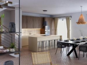 a kitchen and living room with a table and chairs at Wild Adriatic Way in Zagorje