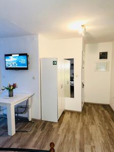 a room with a table and a tv on a wall at Dani Apartments in Split