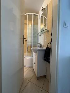 a bathroom with a sink and a shower at Dani Apartments in Split