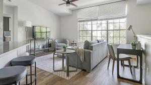 a living room with a couch and a table at Landing Modern Apartment with Amazing Amenities (ID1167X009) in El Paso