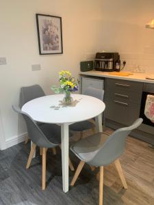 a kitchen with a table and chairs in a room at Ouse House in Swinefleet