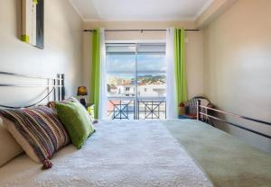 a bedroom with a bed and a large window at Saudades do Sol y Mar Apartment in Lagoa +50 photos