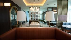 a lobby of a restaurant with a couch and chandeliers at Courtyard by Marriott Santo Domingo Piantini in Santo Domingo