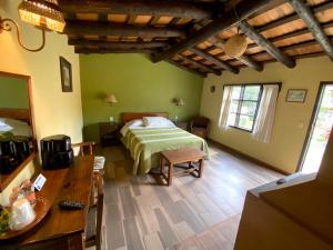 a bedroom with a bed in a room with green walls at Villa Patzcuaro Garden Hotel in Pátzcuaro