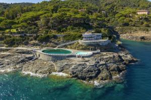 an aerial view of a house on a rocky island in the water at Villa Le Terrazze in Capo D'Arco