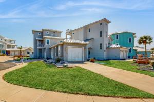 a group of houses with a yard and a driveway at Salty Kisses in Padre Island