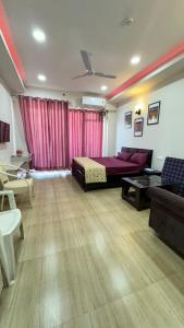 a large room with a bed and a couch and a table at Namoh studio and apartment in Ghaziabad