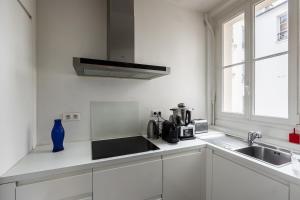 Kjøkken eller kjøkkenkrok på Bright apartment in the heart of Paris - Welkeys