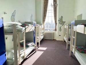 a room with a bunch of bunk beds at Castle Rock Hostel - Adults Only in Edinburgh