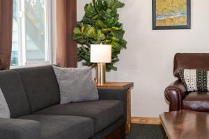 a living room with a couch and a lamp at Gull Lake Lodge in June Lake
