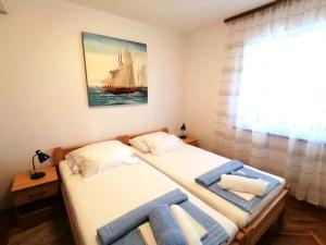 a bedroom with a bed with a sail boat on it at APARTMAN GLORIA in Krk +22 photos