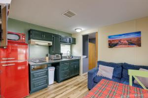 uma cozinha com armários verdes e um frigorífico vermelho em Cozy Morriston Home - Close to HITS Post Time Farm em Morriston