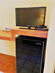 a flat screen tv sitting on top of a desk at Hotel LunaSol in Playa del Carmen