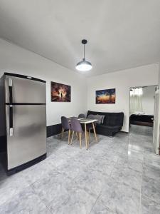 a living room with a refrigerator and a table at Acogedor Apartamento En La Circunvalar By Parceros Group in Pereira