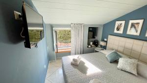a bedroom with a bed with a towel on it at Casa Di Emma (camera Ponente) in Sestri Levante