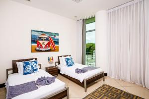 Ένα ή περισσότερα κρεβάτια σε δωμάτιο στο Pura Vida Penthouse W Ocean And Sunset Views +17 φωτογραφίες