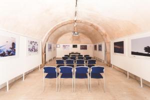 a room with chairs and paintings on the walls at Il Palazzo in Scanno