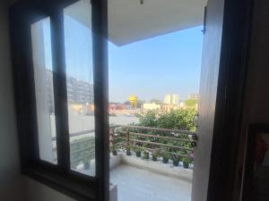 an open window with a view of a balcony at My Space in Agra