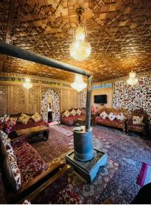 a living room with couches and a fireplace at Lakes Crown Group Of Houseboats in Srinagar
