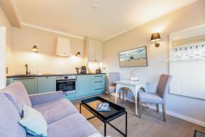 a living room with a couch and a table at Appartement Hamburg in Westerland