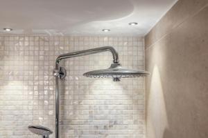 a shower with a shower head in a bathroom at Appartement Hamburg in Westerland