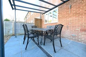 a table and chairs sitting on a patio at Vibrant 3BD home with great links to the city in London