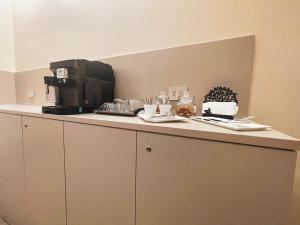 a counter with a coffee maker on top of it at GIO' HOUSE in Fossano
