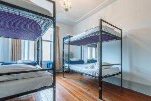 a bedroom with two bunk beds and a chandelier at The Cambie Hostel Gastown in Vancouver