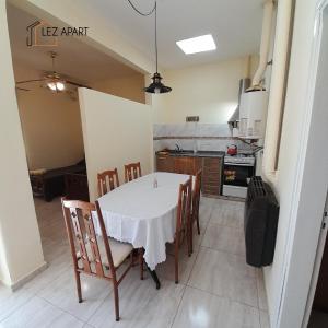 a kitchen with a table and chairs in a room at Apart Dalia, Casa con asador in Río Cuarto