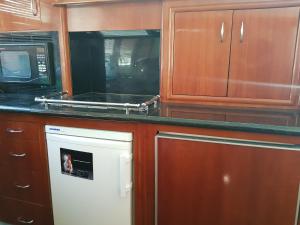 a kitchen with a microwave and a stove top oven at Top Luxury Exclusive Fully air conditioned 3bdr Yacht in Eilat