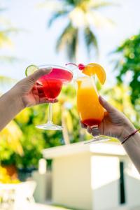two people holding two cocktails in their hands at amaremar in San Luis