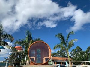 a house with a wooden circle in front of a building at Pousada Sitio Roda D'Água Mairinque in Mairinque