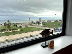 a window with a statue of a fish on a window sill at Seaview Penthouse in Seaham