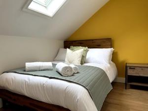a bedroom with a large bed with towels on it at Seaview Penthouse in Seaham