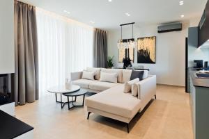 a living room with a white couch and a table at Ioannina Secret Luxury Villas in Ioannina