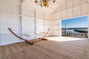 a hammock in a room with a view of the ocean at Tijosa Eco-House Camp in Ovar