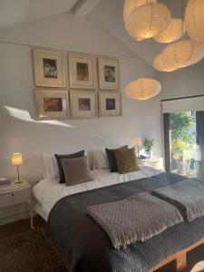 a bedroom with a large bed and some lights at Pound Orchard Bed and Breakfast in Petersfield