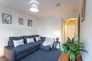 a living room with a couch and a table at April Disc - Long Stay - Contractors in Bristol