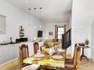 a kitchen and dining room with a table and chairs at Henry House - Uk39786 in Burton in Lonsdale