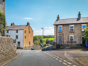 an empty street with two brick buildings and a street light at Henry House - Uk39786 in Burton in Lonsdale