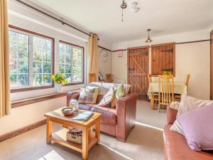 a living room with a couch and a table at Little Meadow in Two Bridges